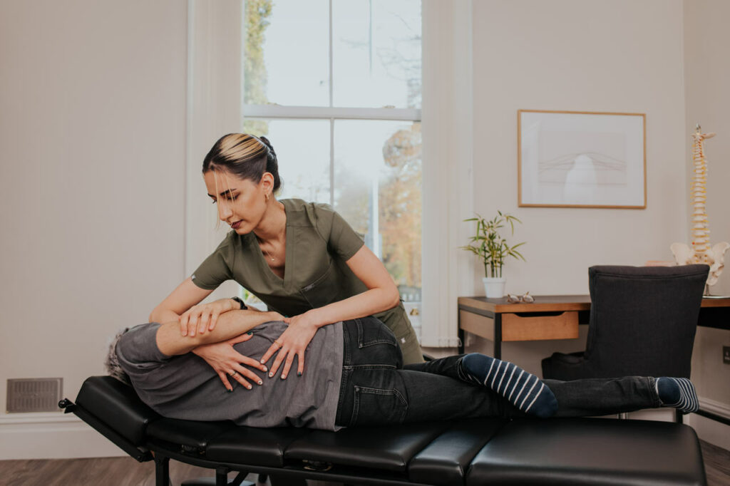 Stockport Osteopath treating patient's back